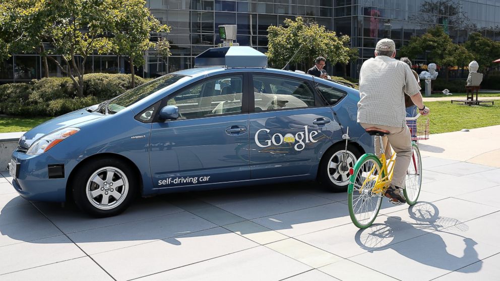 PHOTO: A bicyclist rides by a Google self-driving car at the Google headquarters, Sept. 25, 2012 in Mountain View, California.
