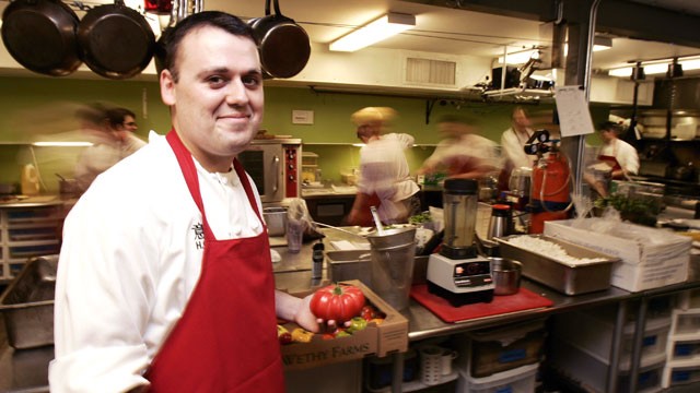 PHOTO: Chef Homaro Cantu holds a tomato in the kitchen of his new restaurant called "Moto" in Chicago, Illinois, May, 15, 2007.