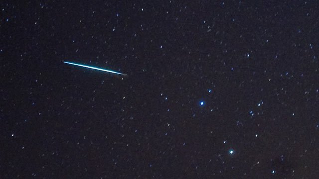 PHOTO: A meteor from the Geminids meteor shower enters the Earths atmosphere past the stars Castor and Pollux (two bright stars, R),above Southold, New York, Dec. 12, 2009.