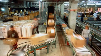 PHOTO: Boxes on conveyor belt in a mailroom.
