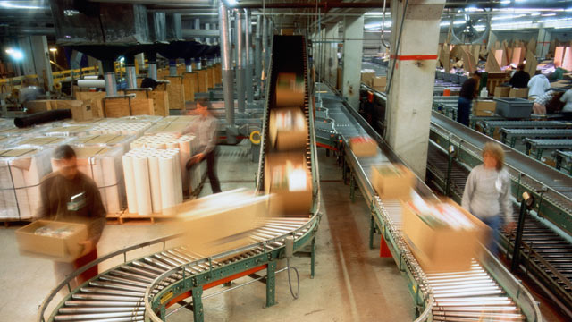 PHOTO: Boxes on conveyor belt in a mailroom.
