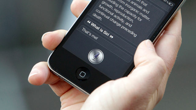 PHOTO: A customer demonstrates the Siri function on an Apple Inc. iPhone 4S smartphone outside the companys store in this Oct. 14, 2011 file photo.