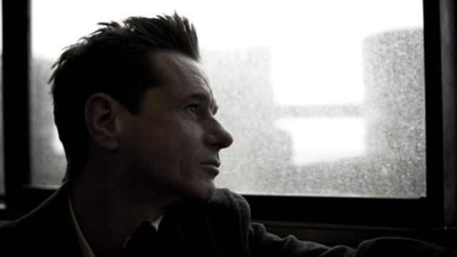 PHOTO: Solitary man looking out window