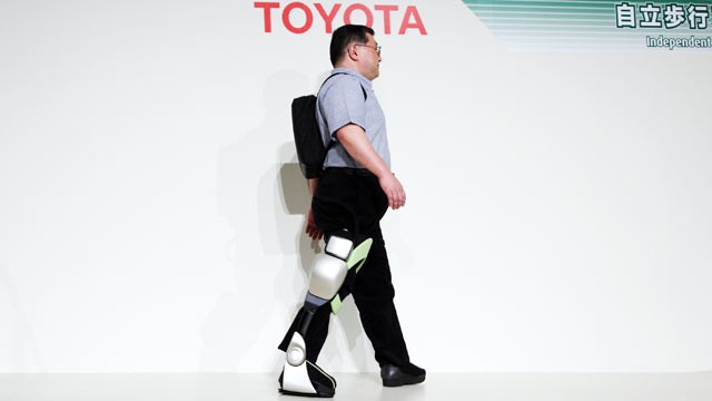 PHOTO: Eiichi Saito, a professor at Fujita Health University, demonstrates an Independent Walk Assist robot at a Toyota Motor Corp.