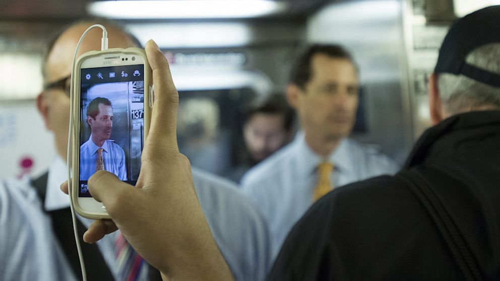 PHOTO: A passenger takes a cell phone photo of mayoral hopeful Anthony Weiner on a subway train