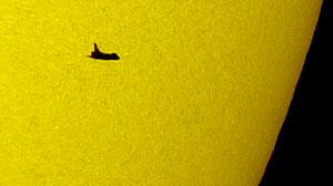 Photo: The space shuttle Atlantis silhouetted against the Sun.