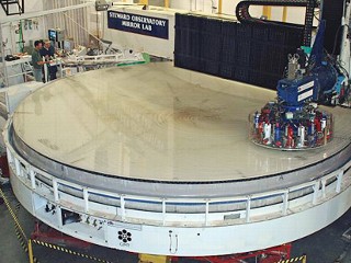 This photo shows a giant telescope mirror being polished at the University of Arizona. The same technology that produced this mirror would be used to make solar concentrators.