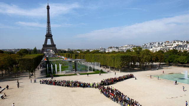 PHOTO: People power rivals the Eifel Tower in Paris, France as residents form a giant wind turbine with their bodies.