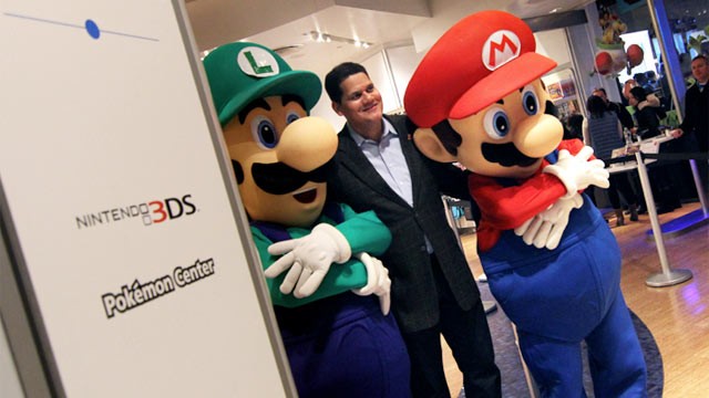 PHOTO: Nintendo of America President Reggie Fils-Aime poses with Mario and Luigi on Wii U launch night.