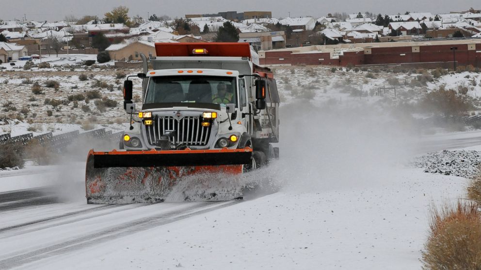 PHOTO: A plow and sanding truck clears a road after a winter storm hit New Mexico, making driving difficult in Albuquerque, N.M., Nov.24, 2013.