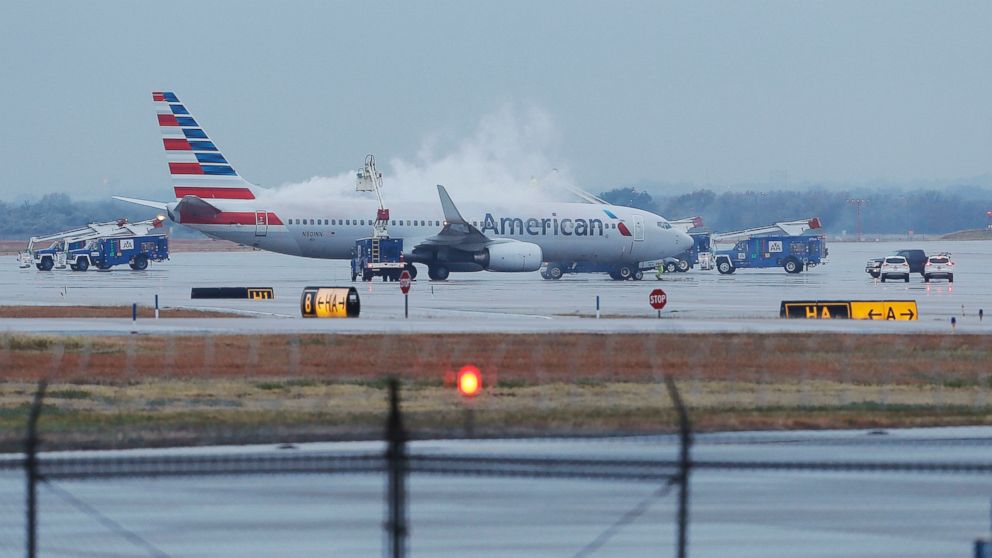 PHOTO: Crews spray deicing solution onto an American Airlines 737 before departure at Dallas-Fort Worth International airport, Nov. 25, 2013.