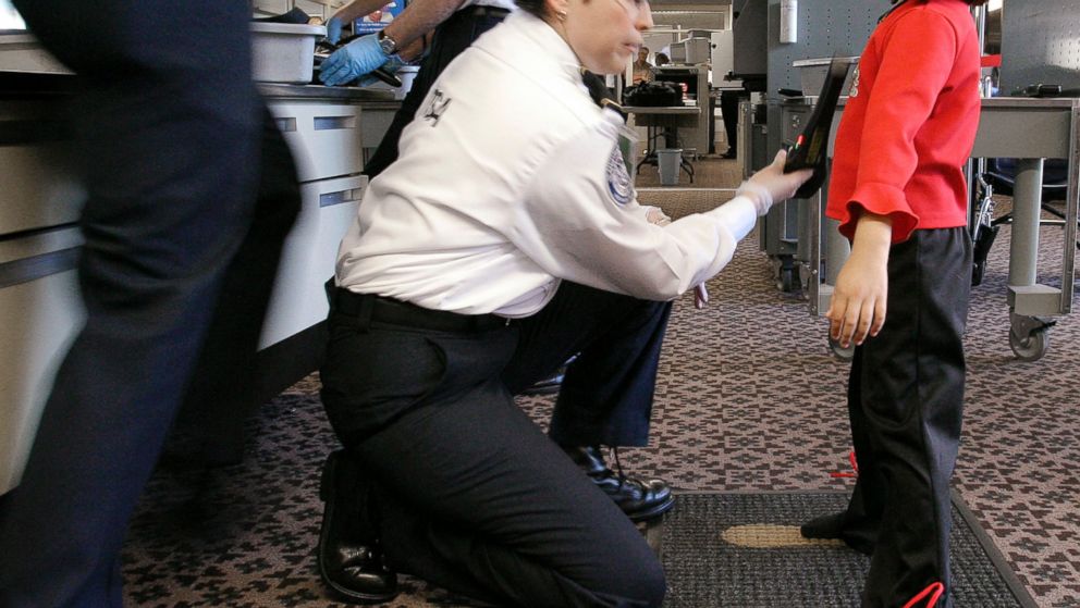 PHOTO: A TSA agent performs a pat-down check on a young girl at a security checkpoint at Phoenix Sky Harbor International Airport, December 2004, in Phoenix.