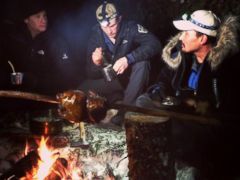 PHOTO: ABCs Neal Karlinsky, left, Dallas Seavey, center, and Eddie Ahyakak, right, sit around a campfire in the Alaskan wilderness.