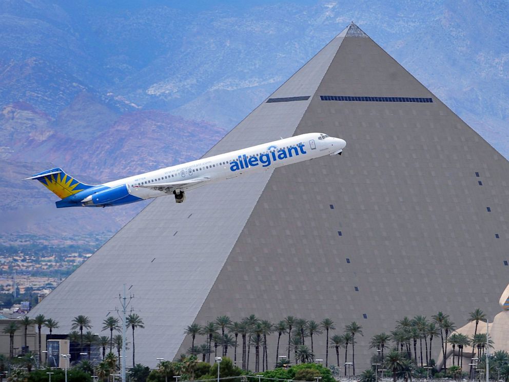 PHOTO: In this May 9, 2013, photo, an Allegiant Air jetliner flies by the Luxor Resort & Casino after taking off from McCarran International Airport in Las Vegas. Allegiant Air has been profitable for 10 straight years.