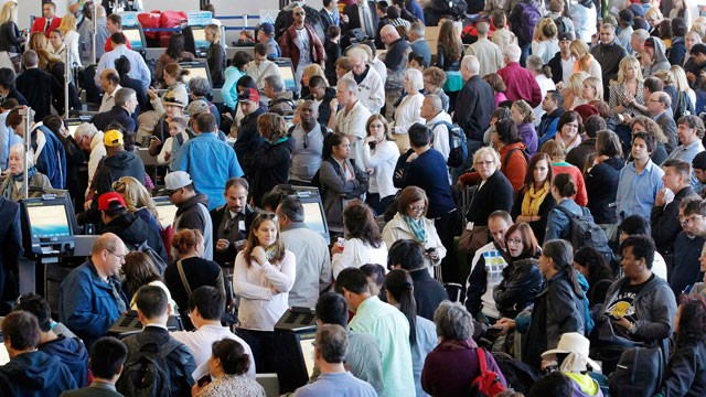 PHOTO: Passengers gather at the American Airlines check-in for flights at Los Angeles International Airport, April 16, 2013.