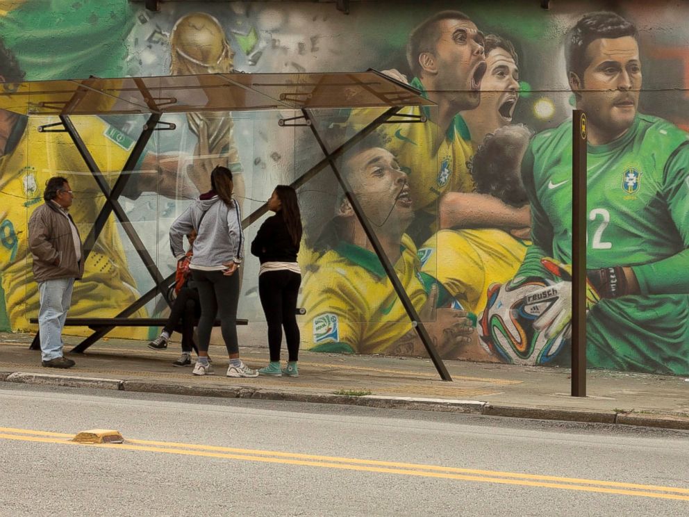 PHOTO: A mural of Brazilian soccer player Neymar, right, and others cover a wall by a bus stop in Sao Paulo, Brazil, May 26, 2014.