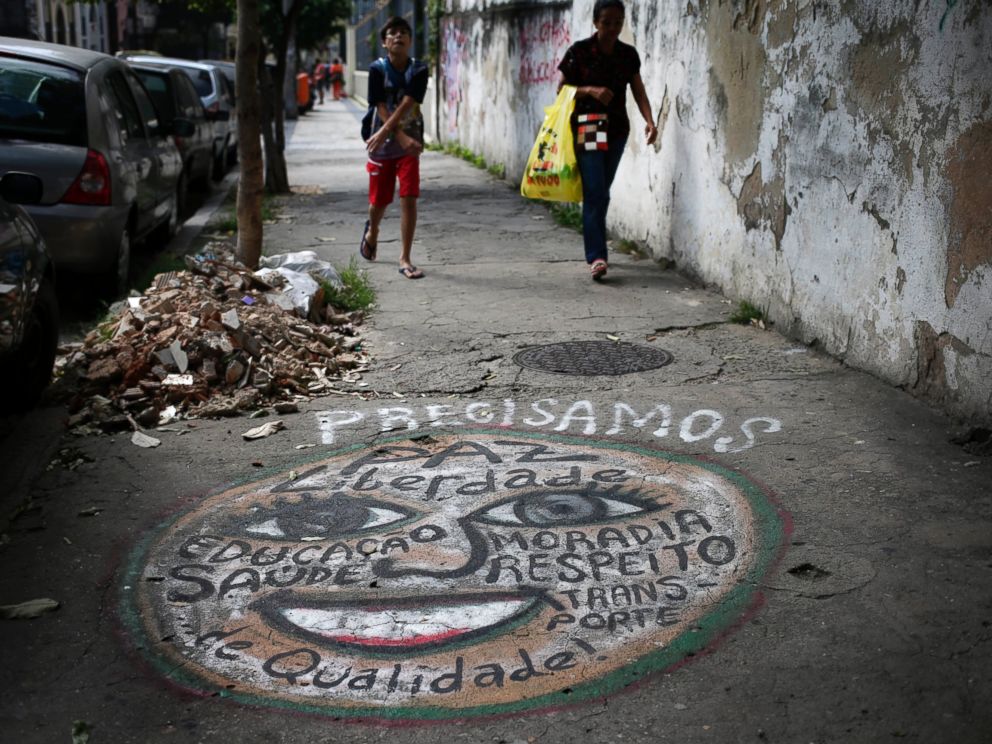 PHOTO: A mural that lists many wants including better quality health care, peace, freedom, homes and transportation, adorns a sidewalk in Rio de Janeiro, Brazil, May 21, 2014.