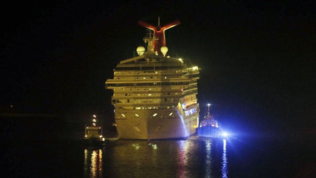 PHOTO: The cruise ship Carnival Triumph is towed up the Mobile River in Mobile, Ala., Thursday, Feb. 14, 2013. The ship with more than 4,200 passengers and crew members has been idled for nearly a week in the Gulf of Mexico following an engine room fire.
