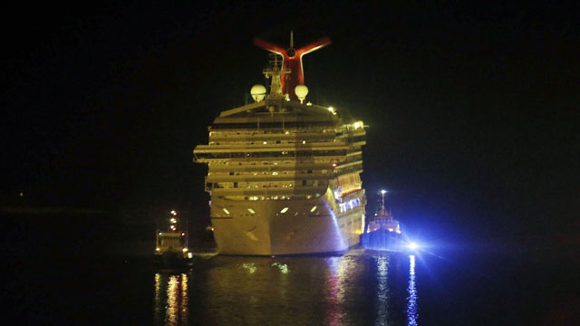 PHOTO: The cruise ship Carnival Triumph is towed up the Mobile River in Mobile, Ala., Thursday, Feb. 14, 2013. The ship with more than 4,200 passengers and crew members has been idled for nearly a week in the Gulf of Mexico following an engine room fire.