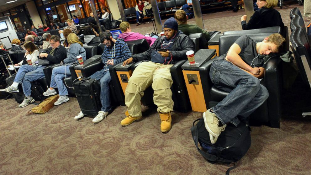 PHOTO: Travelers wait for a flight at a terminal gate at Phoenix Sky Harbor Airport in Phoenix on Nov. 26, 2013.
