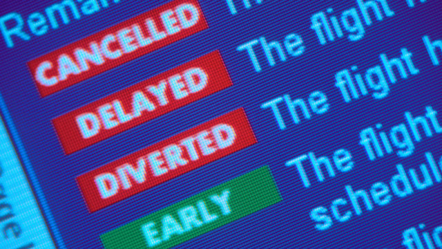 PHOTO: A departure board at the airport shows delays and cancellations.
