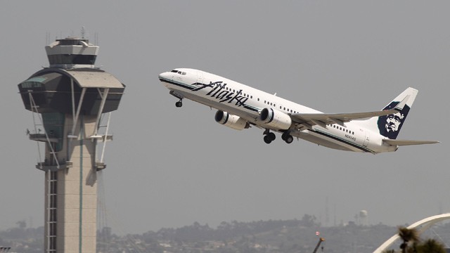 PHOTO: An Alaska Airlines jet passes the air traffic control tower at Los Angles International Airport during take-off on April 22, 2013 in Los Angeles.
