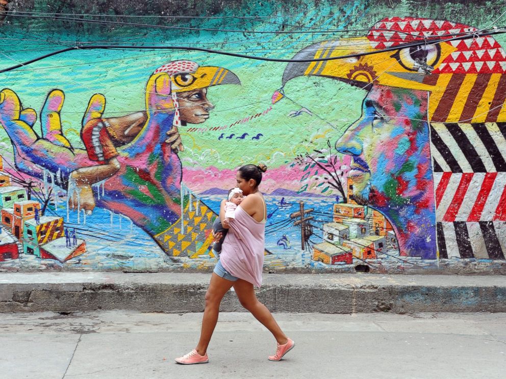 PHOTO: A woman and her baby walk in the streets of the Cantagalo favela, next to Copacabana on April 23, 2014, in Rio de Janeiro.