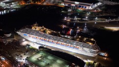 PHOTO: Crippled cruise ship, Carnival Triumph, moves into port guided by tug boats on Feb. 14, 2013 in Mobile, Ala.