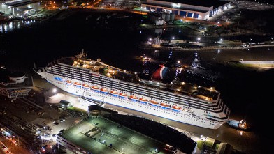 Crippled cruise ship, Carnival Triumph, moves into port guided by tug boats on Feb. 14, 2013 in Mobile, Ala.