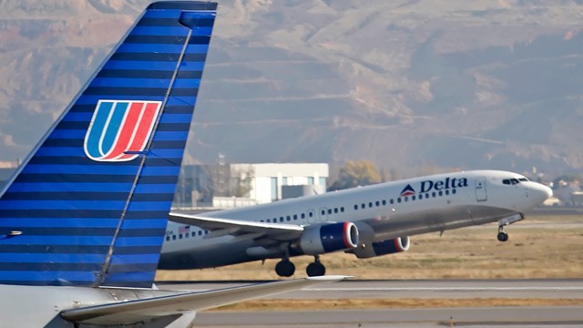 PHOTO: A Delta plane makes its way past a United plane at the Salt Lake City Airport in Salt Lake City, Utah, U.S., on Nov. 15, 2007.
