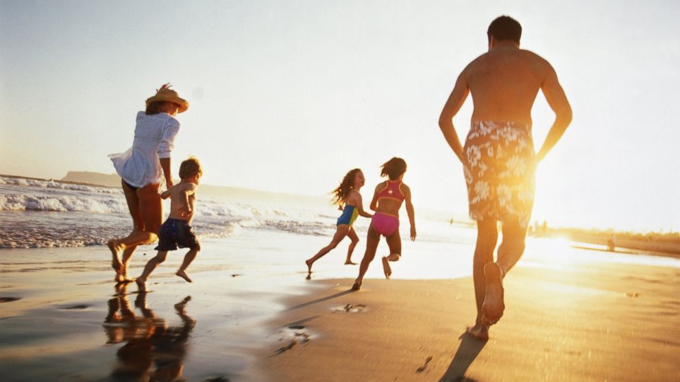PHOTO: A family runs on the beach at sunset in this undated stock photo.