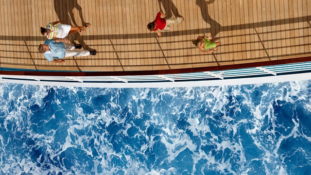 PHOTO: An aerial view of a family on a cruise ship and the ocean.