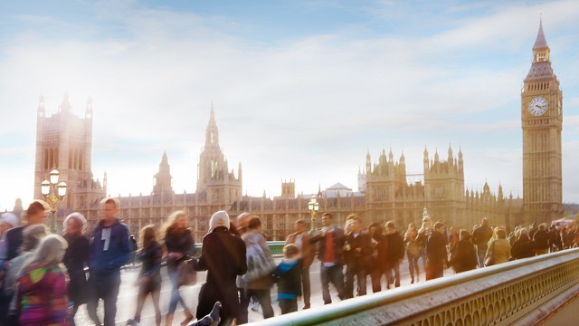 Tourists cross the River Thames on a foot bridge, in London, in this file photo.