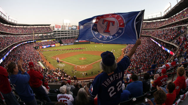 PHOTO: A fan waves a flag during Game Four of the MLB World Series between the St. Louis Cardinals and the Texas Rangers at Rangers Ballpark in Arlington on Oct. 23, 2011 in Arlington, Texas.