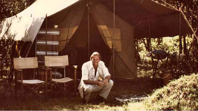 PHOTO: Geoffrey Kent in Kenya, about 1970. He said in those days, the most important thing was to find a sturdy branch at just the right height to support a canvas shower bucket.