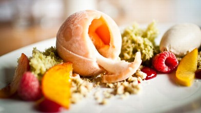 PHOTO: The frosty peach sphere that dominates this dessert is actually sorbet, with a relatively healthy peach and fresh raspberry filling.