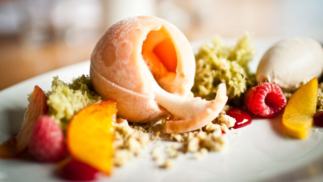 PHOTO: The frosty peach sphere that dominates this dessert is actually sorbet, with a relatively healthy peach and fresh raspberry filling.