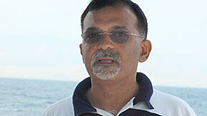 Sanjeev Midha has one of the country?s largest passports. Here he is in Greece.