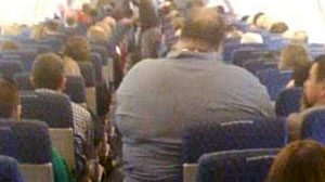 Photo: How Fat is Too Fat to Fly? This Man Hardly Looks Comfortable on the Airplane and Surly Isnt Seated Safely