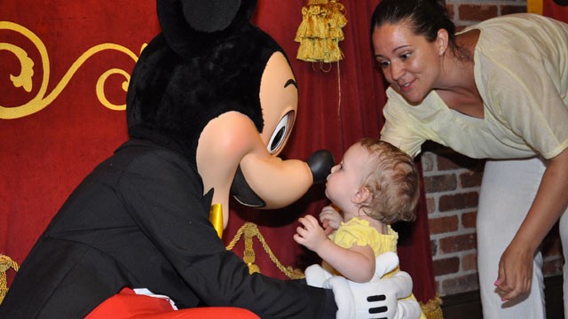 PHOTO: 18-month-old Ellie gives her new friend Mickey a kiss in Disney's Magic Kingdom, while Mom beams.
