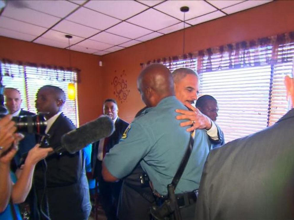 Attorney General Eric Holder greets Captain Ron Johnson in Ferguson, Mo., Aug. 20, 2014.