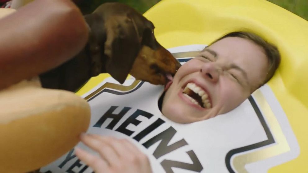 VIDEO: Dachshunds dressed as hot dogs run to their human-condiment counterparts in the commercial.