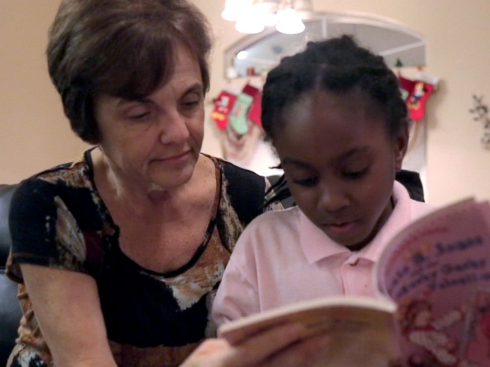 PHOTO: Janet Sylvester reads to one of her five foster children.