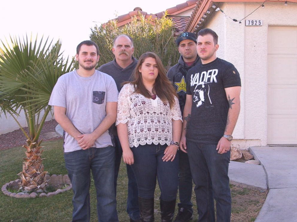 Bob Meyers (second from left) stands in front of his home where his wife Tammy Meyers was shot with their children Matthew Meyers (left), Kristal Meyers (center), Robert Meyers (second from right) and Brandon Meyers (right).
