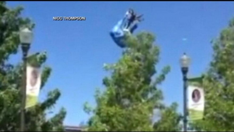 PHOTO: A bounce house went airborne, slamming into lamp posts and a car.