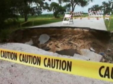 Mother, Son Drive Into Sinkhole, Truck Rides Over Them