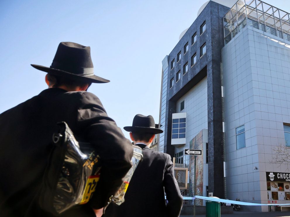 PHOTO: Two young men who left a nearby synagogue watch police activity outside the Jewish Childrens Museum following a bomb threat in Brooklyn borough of New York, March 9, 2017.