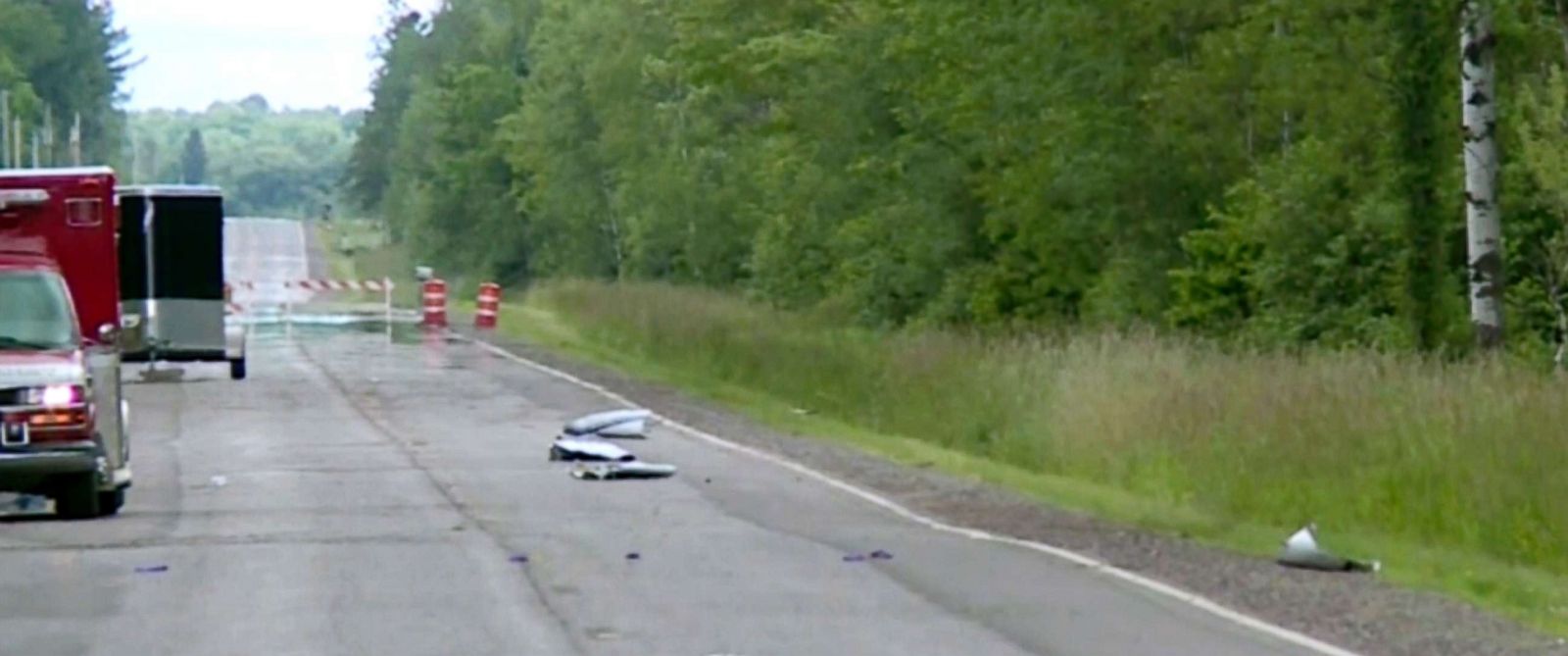 PHOTO: Debris covers the road, July, 2, 2017, near Phillips, Wis., after several people were killed in an airplane crash.