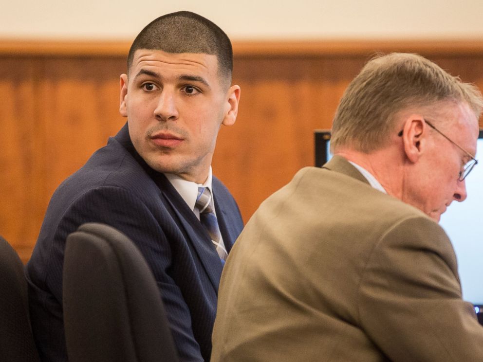 PHOTO: Former New England Patriots football player Aaron Hernandez, left, looks back as he sits with his attorney Charles Rankin during his murder trial, Feb. 13, 2015, in Fall River, Mass.