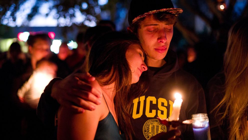 PHOTO: Two students comfort each other during a May 24, 2014 candlelight vigil held to honor the victims of a mass shooting in Isla Vista, Calif.